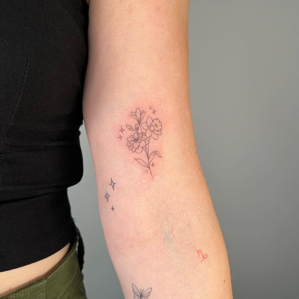 Delicate Narcissus Floral Tattoo with Sparkles december birth flower tattoo ideas tattoo