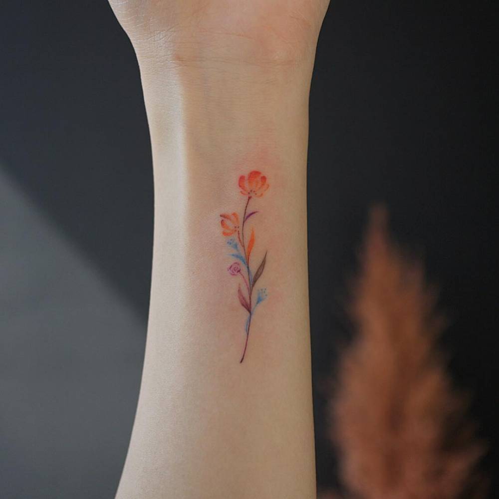 Delicate Watercolor Wildflower Tattoo flower wrist tattoo ideas tattoo