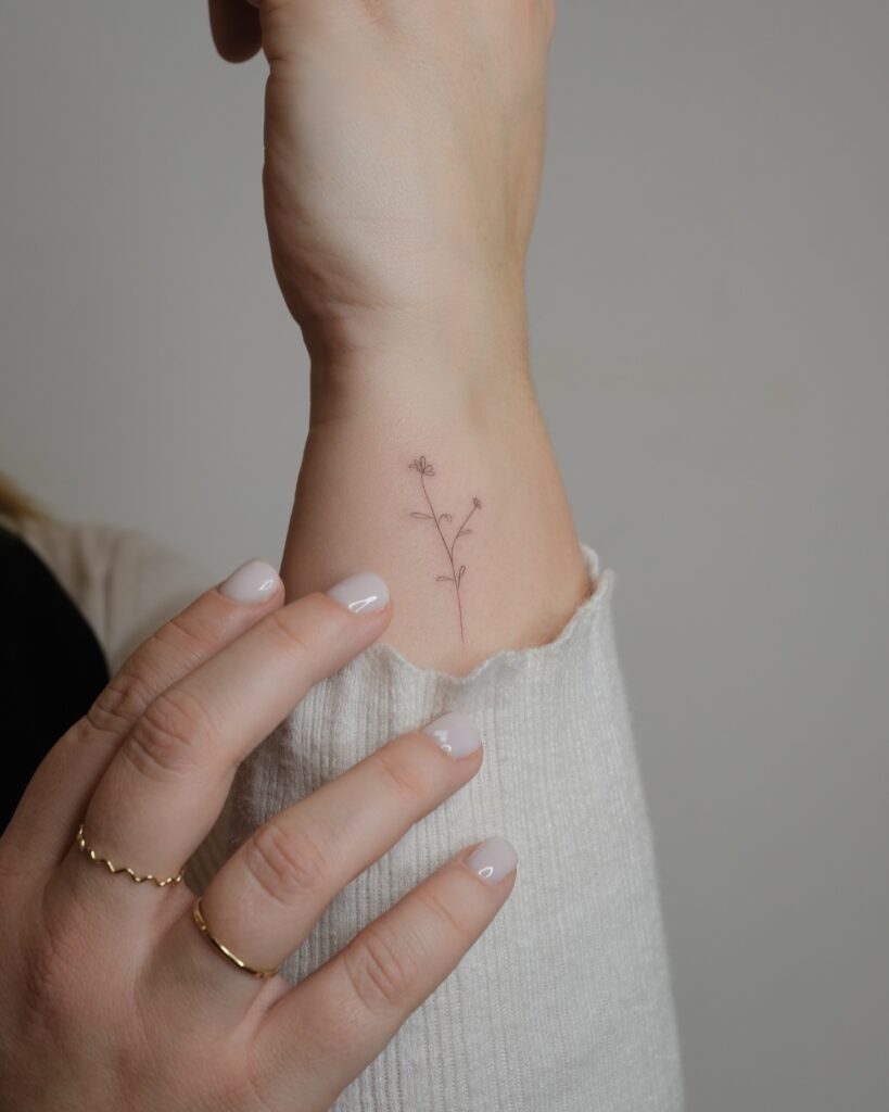 Delicate Wildflower Wrist Tattoo meaningful tiny tattoos tattoo