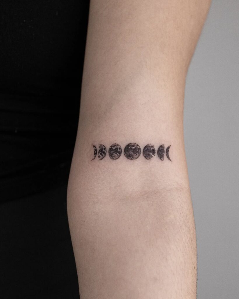 Detailed stippled moon phases forearm tattoo