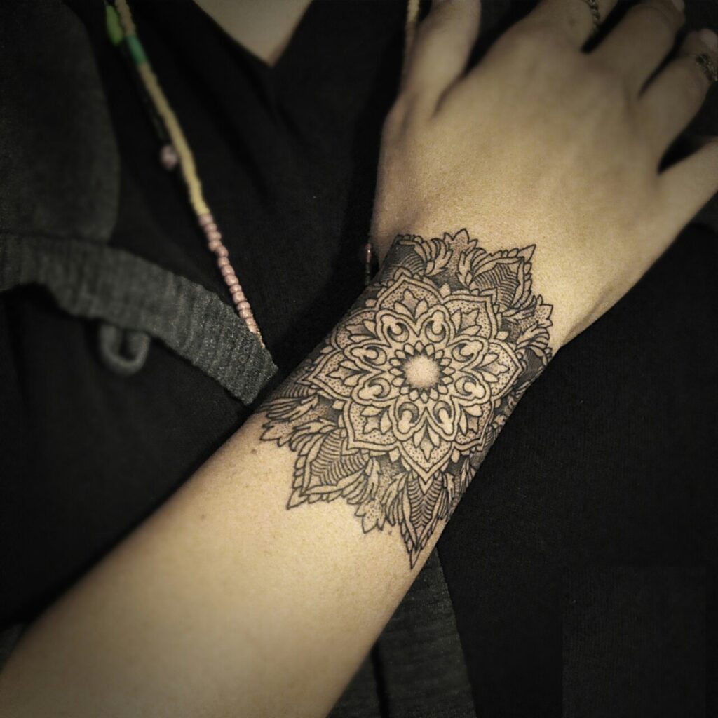 Detailed Mandala Wrist and Hand Tattoo with Leaf Accents mandala wrist tattoo ideas tattoo