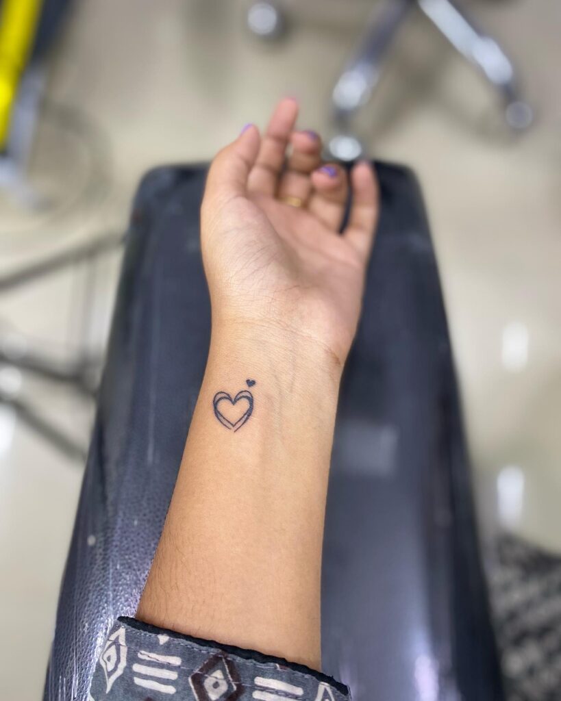 Minimalist Heart with Cross Line Tattoo small heart tattoo ideas tattoo