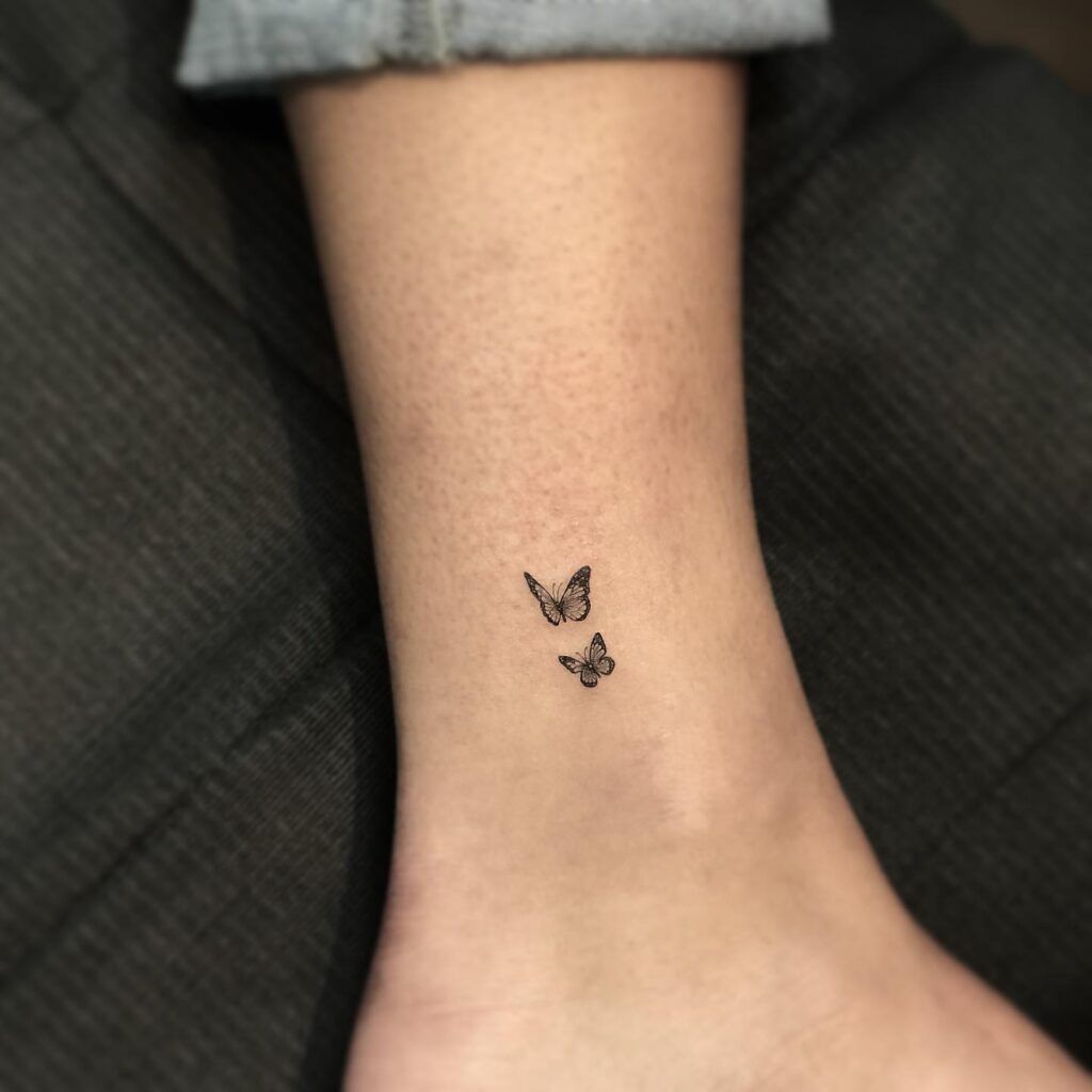 Two small monarch butterfly tattoos on ankle