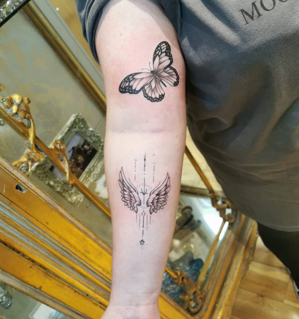 Elegant Angel Wings and Arrow Tattoo on Forearm angel wings tattoo ideas tattoo