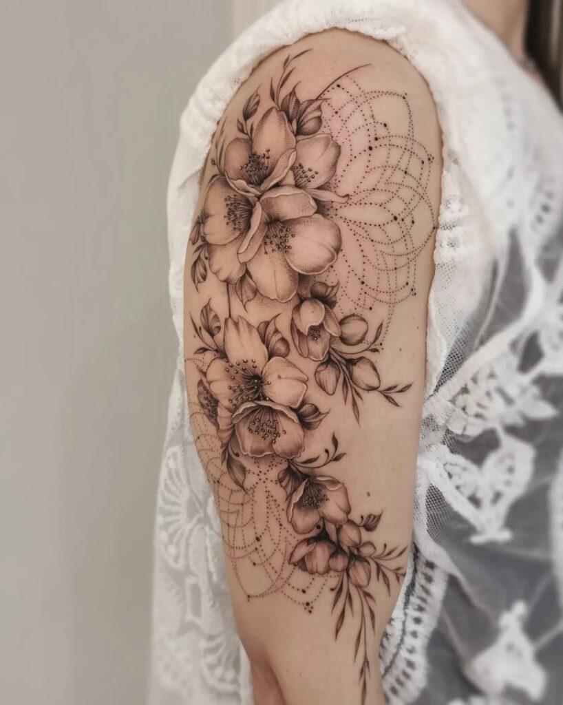Cross And Roses Negative Space Upper Arm Tattoo