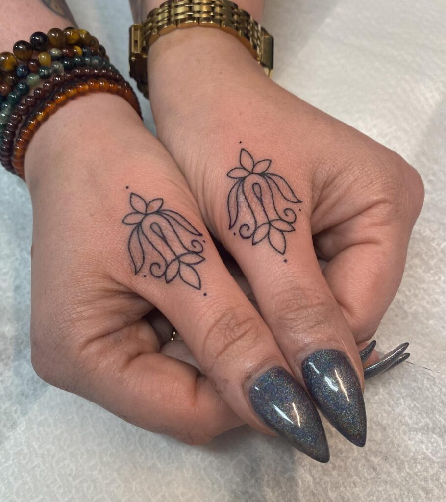 Minimalist Upside-Down Cross Finger Tattoo