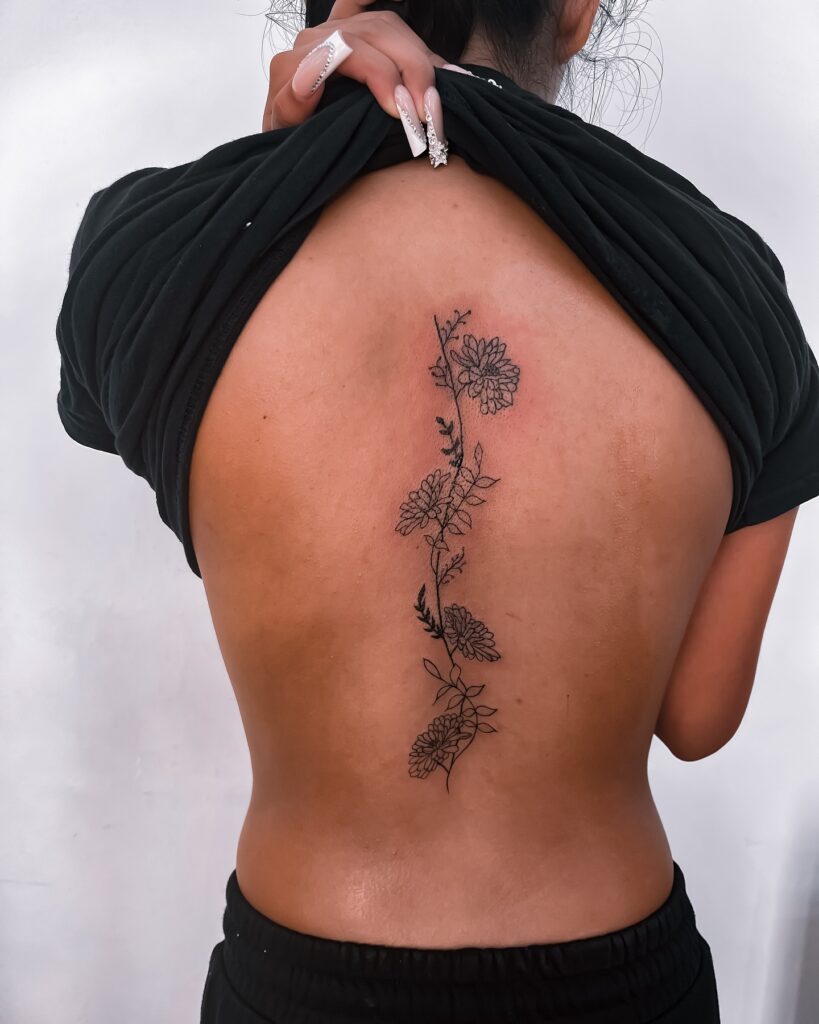 Minimalist Lotus And Inspirational Quote Spine Tattoo