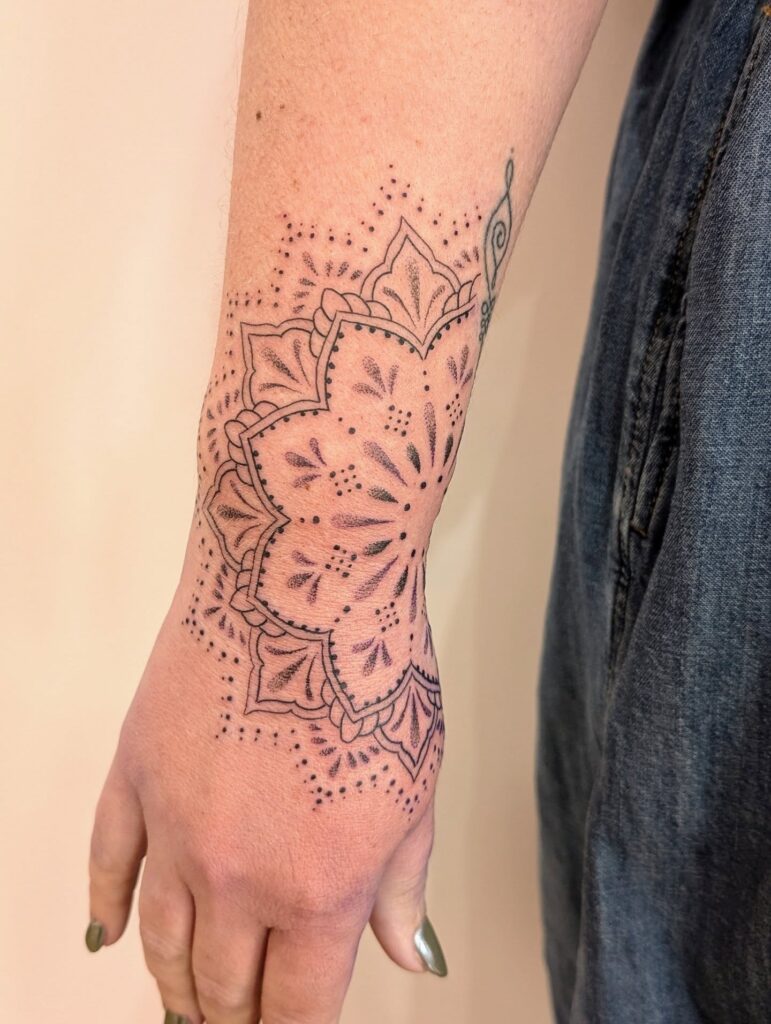 Elegant Hand Mandala Tattoo with Delicate Dotted Accents mandala wrist tattoo ideas tattoo