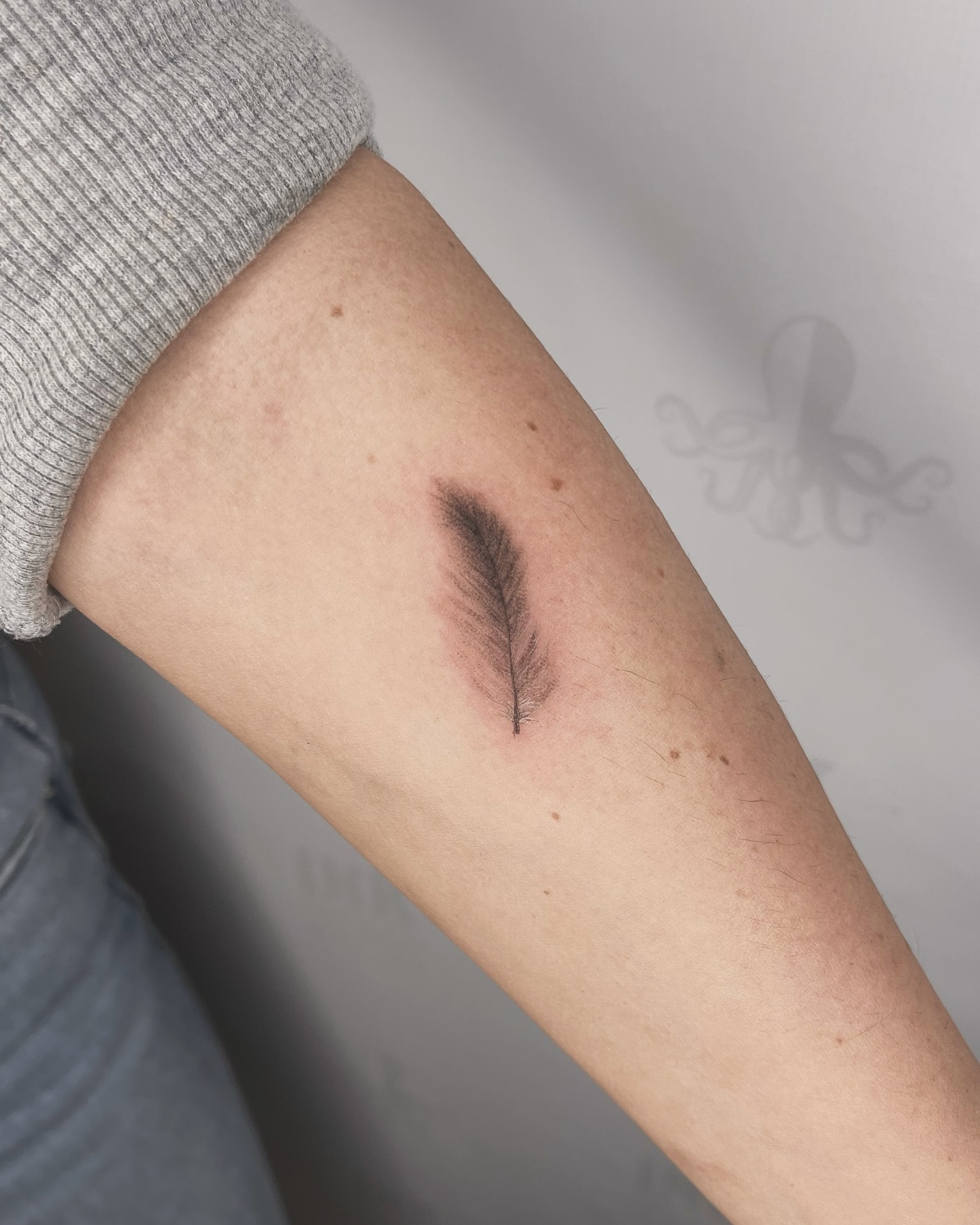 Minimalist Fine Line Feather Tattoo