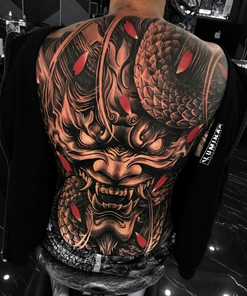 Fierce Japanese Oni and Dragon Back Tattoo with Red Accents back tattoos for guys tattoo