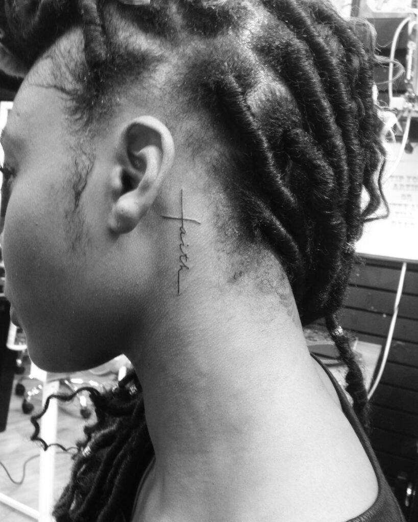 Delicate vertical faith script behind the ear