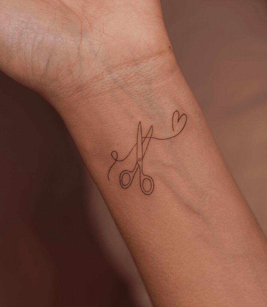 Fine Line Fern Frond on Spine fine line tattoo