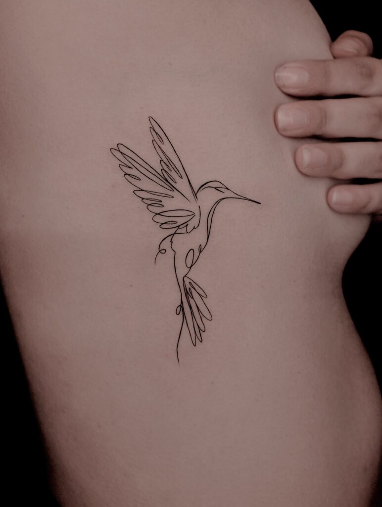Fine Line Hummingbird Tattoo on Ribcage fine line tattoos for women tattoo