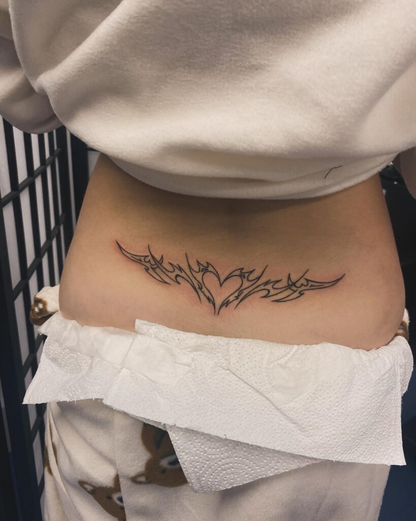 Fine Line Tribal Heart Lower Back Tattoo