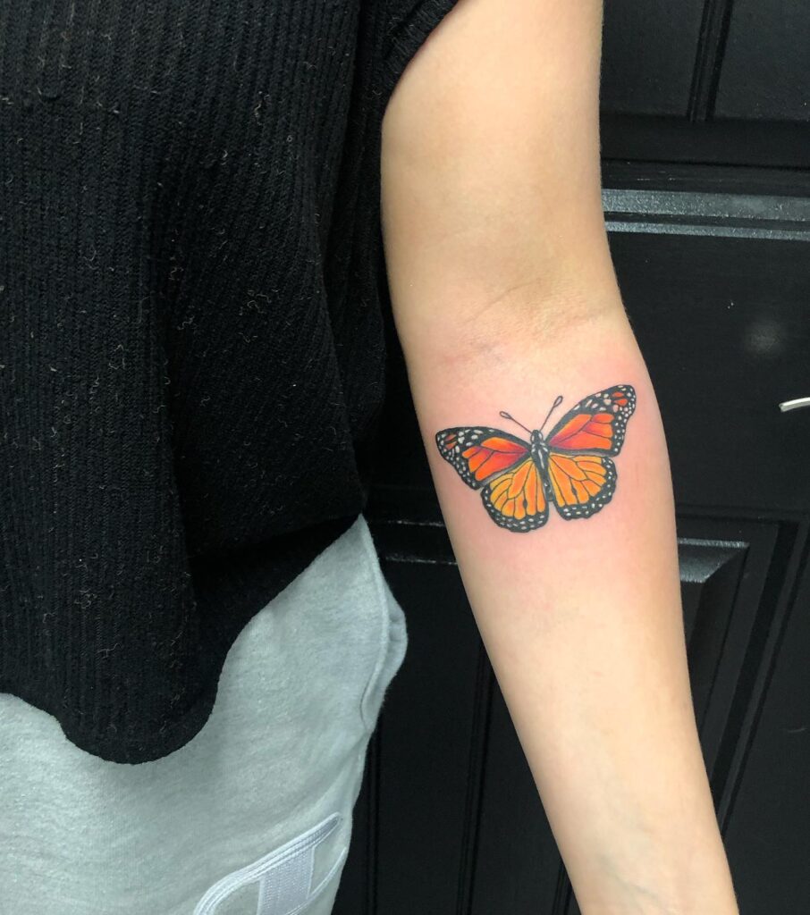 Monarch butterfly tattoo on inner forearm