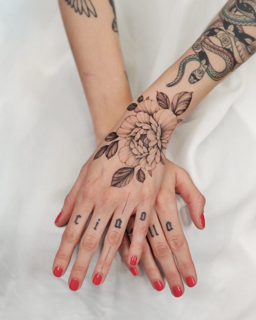 Hand Tattoos With Floral And Symbolic Motifs