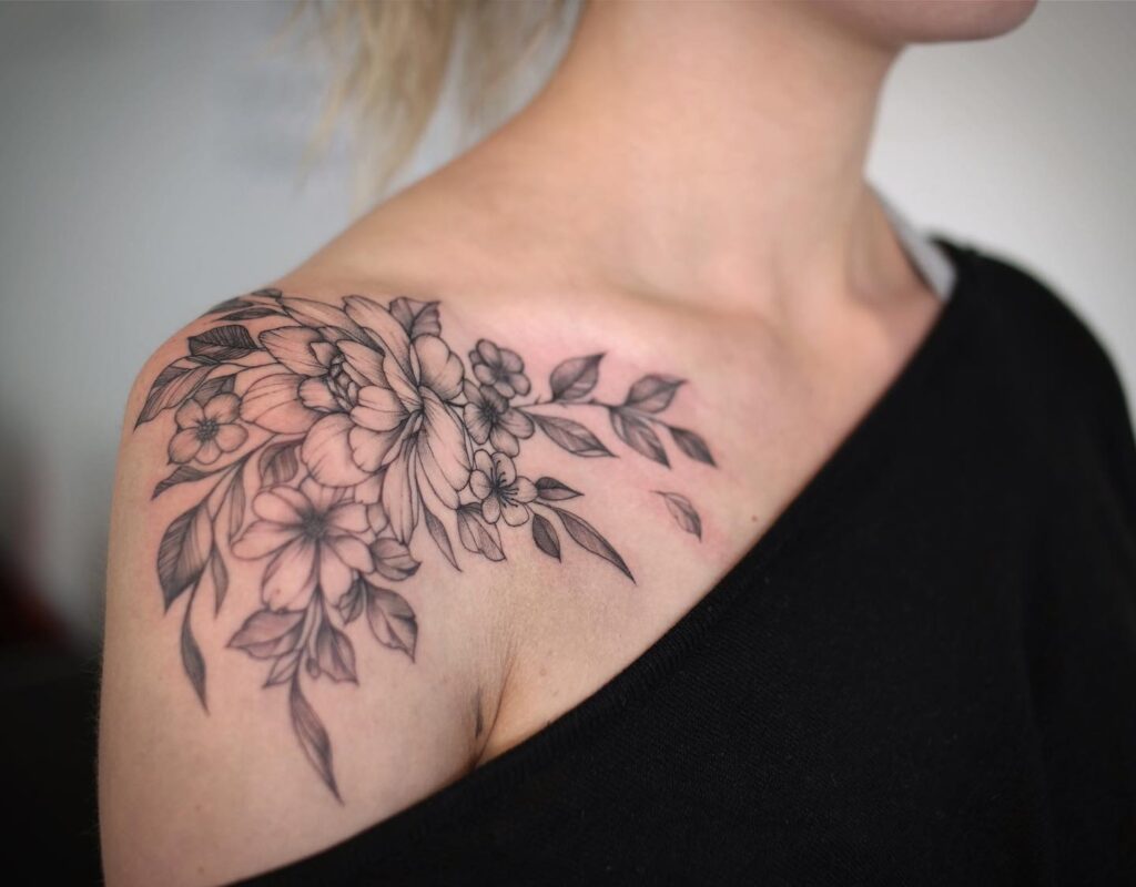Flowing Floral Shoulder Tattoo with Extended Leaves women shoulder flower tattoo ideas tattoo