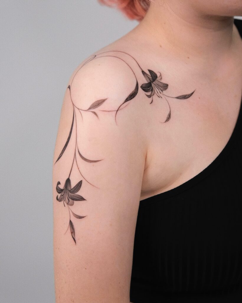 Flowing Lily Shoulder Tattoo women shoulder flower tattoo ideas tattoo