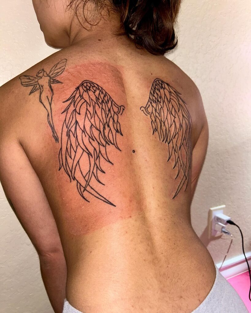 Flowing Outline Angel Wings Tattoo on Back angel wings tattoo ideas on back tattoo