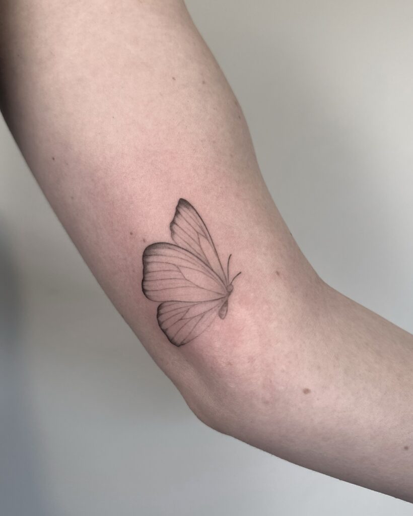 Fluttering Monarch Silhouette with Negative Space butterfly tattoo