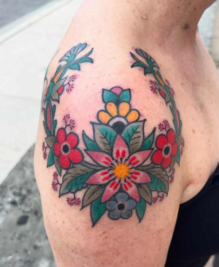 Folk-Inspired Floral Shoulder Tattoo women shoulder flower tattoo ideas tattoo
