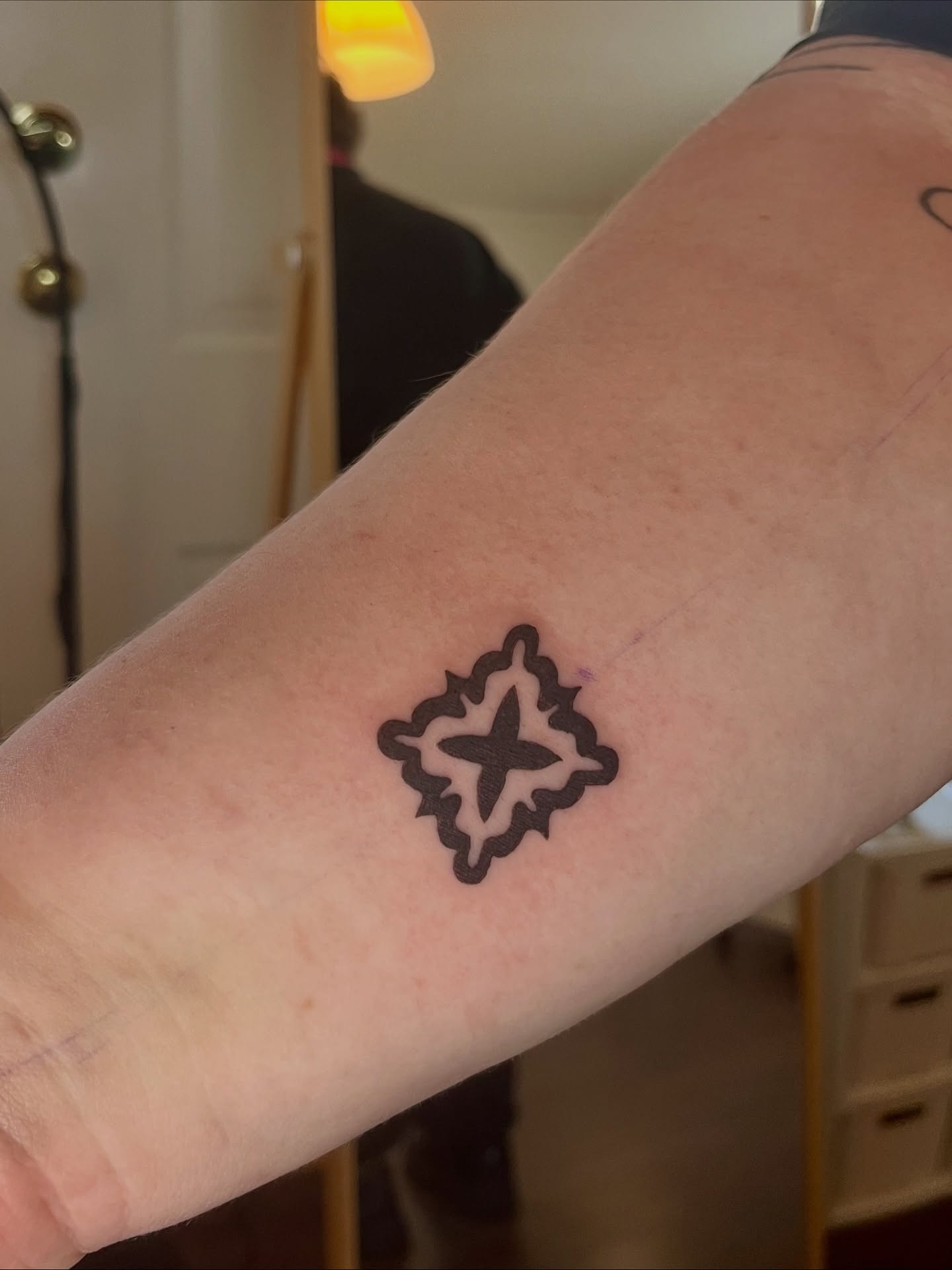 Geometric Cross Forearm Tattoo