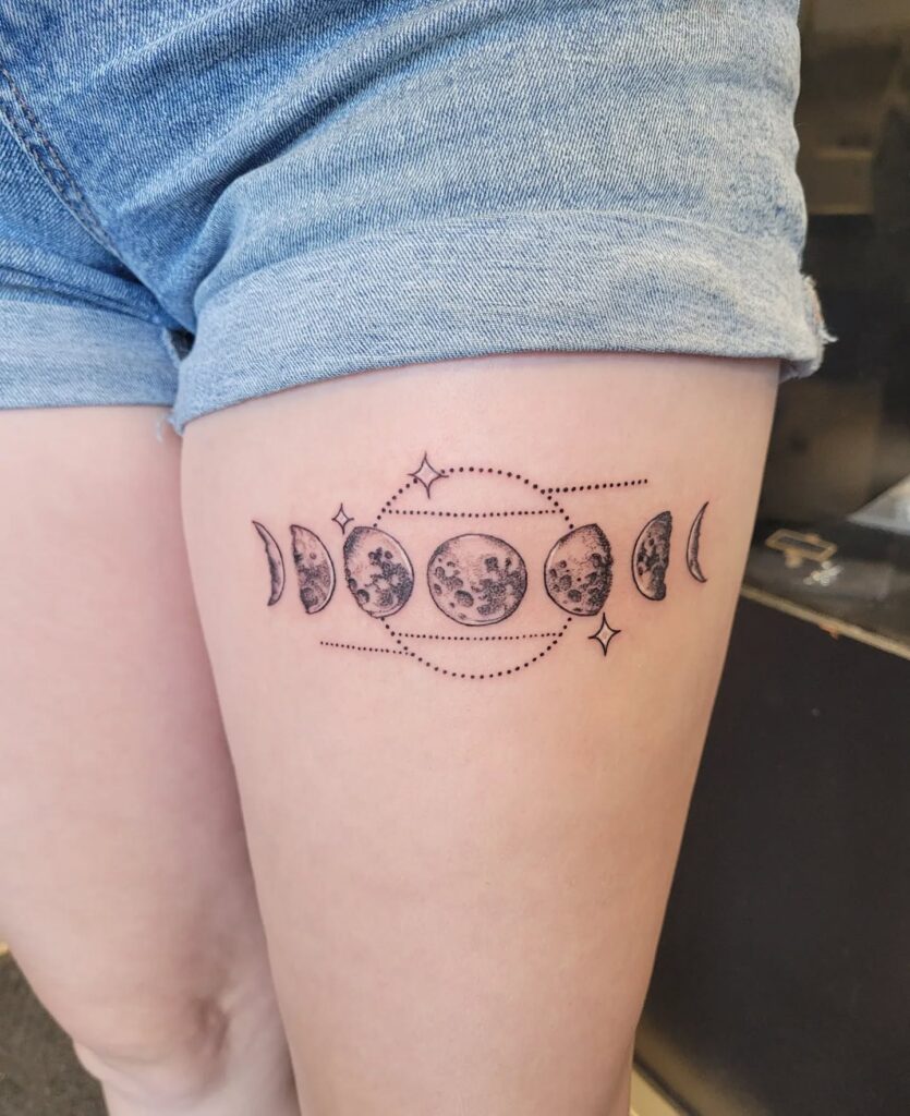 Geometric moon phases thigh tattoo
