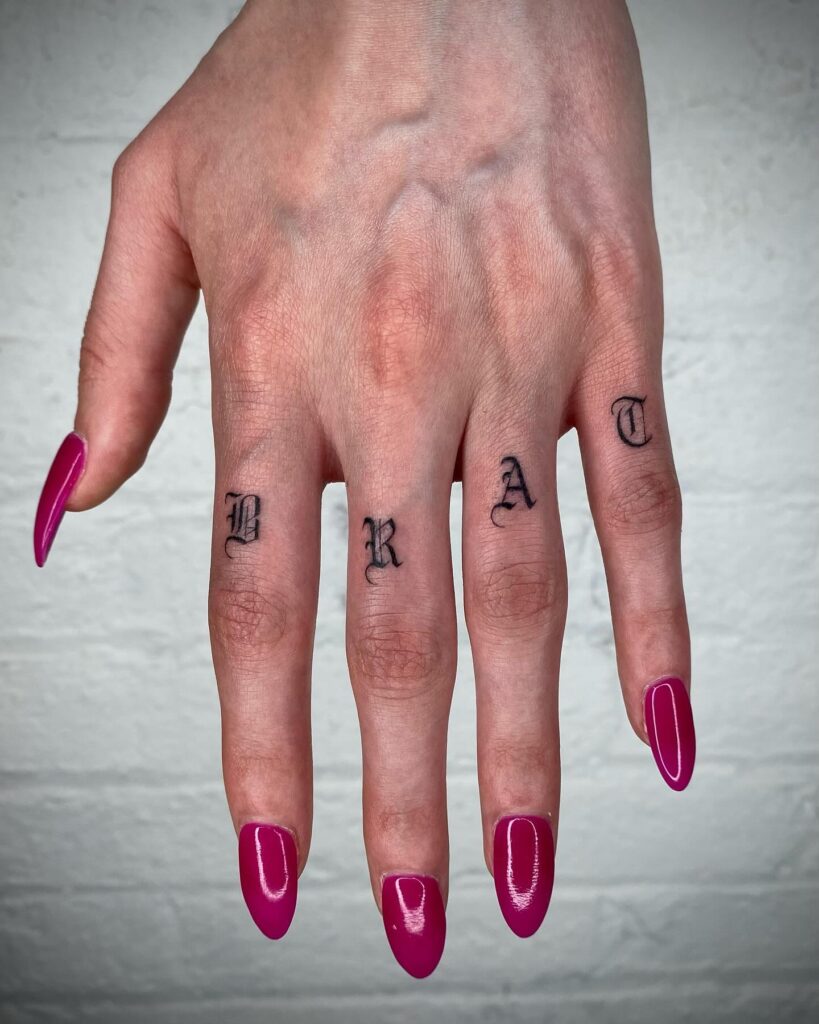 STAY TRUE Script Finger Tattoos With Ornamental Dots