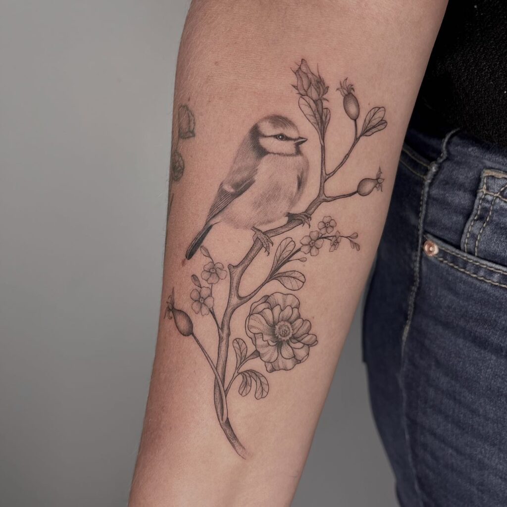 Graceful Bird and Botanical Forearm Tattoo bird tattoo ideas for women with meaning tattoo