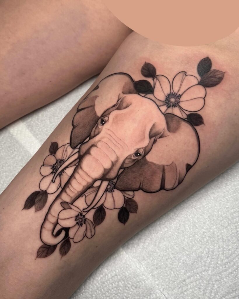 Graceful elephant and flower tattoo on arm