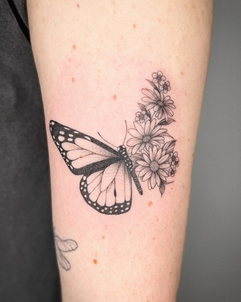 Half monarch butterfly half floral tattoo