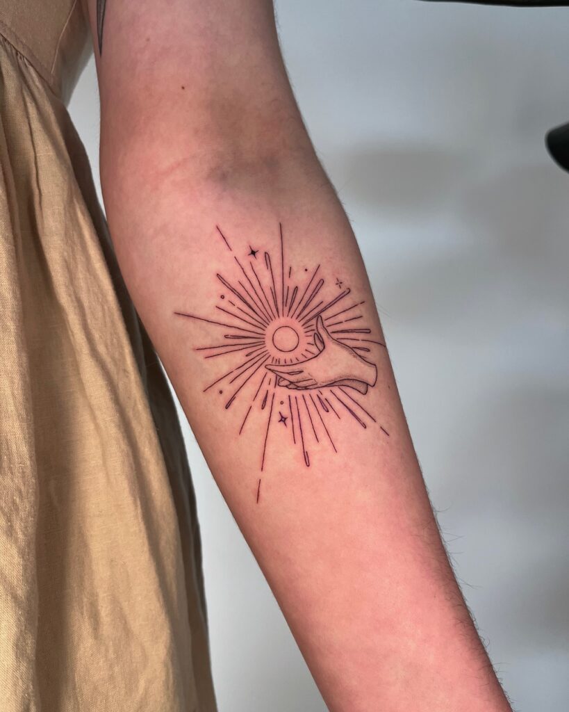 Hand Holding the Sun Tattoo