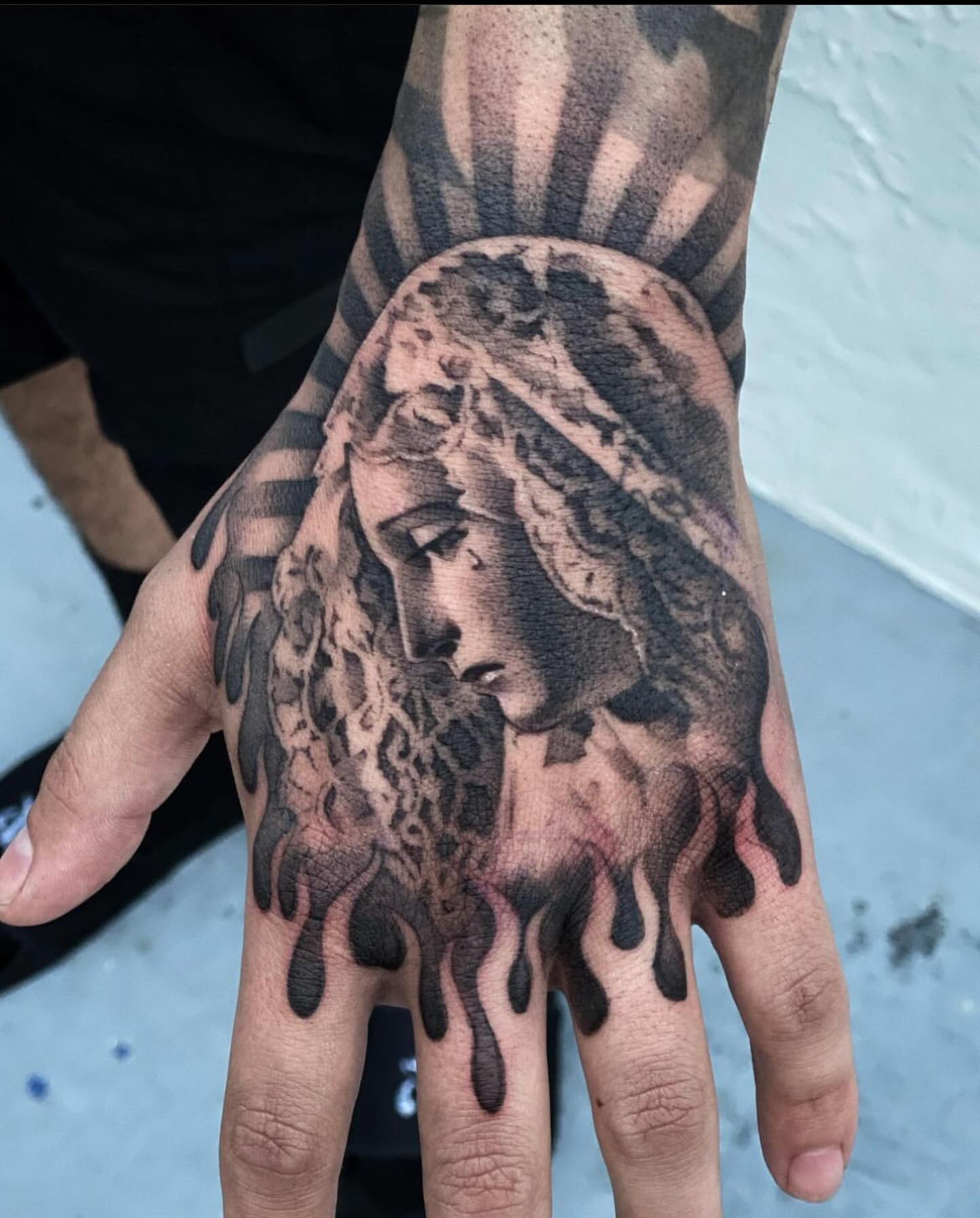 Virgin Mary Portrait Hand Tattoo