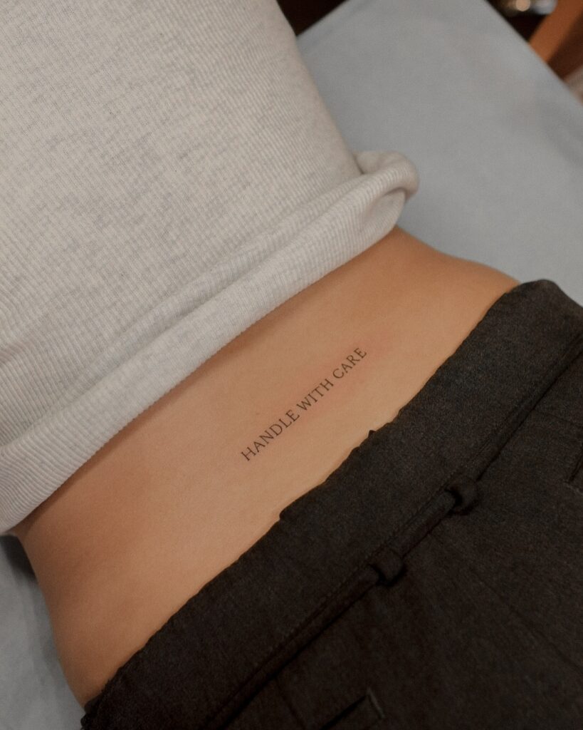 Handle With Care Back Tattoo