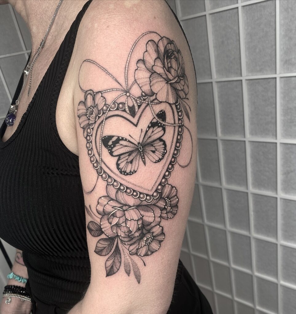 Heart Locket With Butterfly And Flowers Upper Arm Tattoo