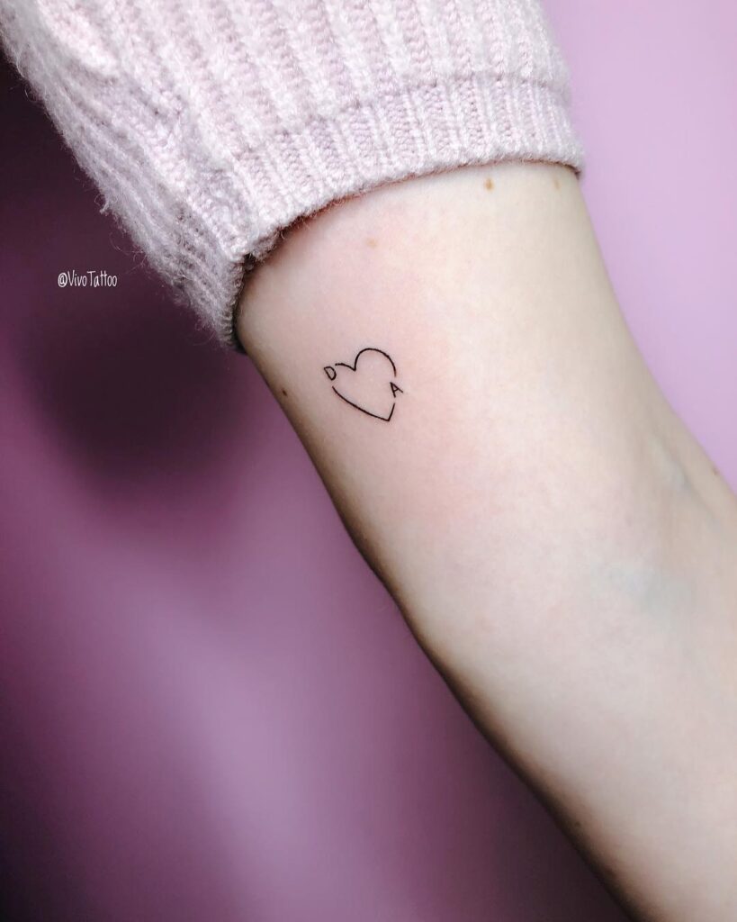 Minimalist Heart with Tiny Accents small heart tattoo ideas tattoo