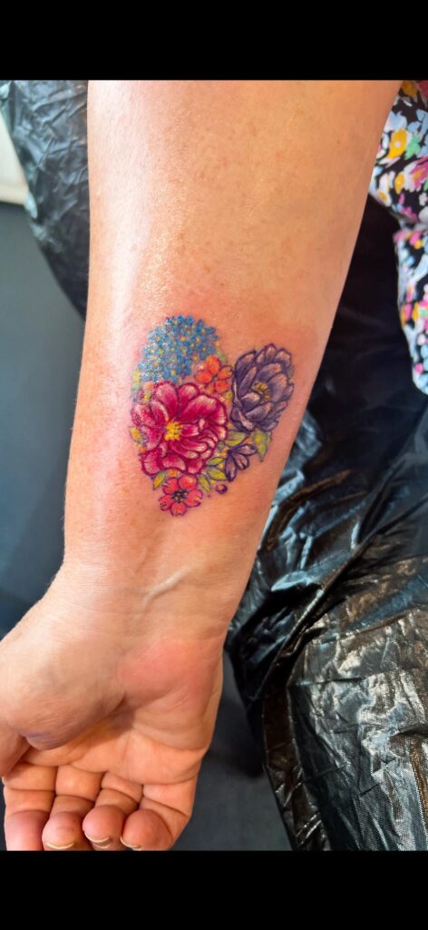 Heart-Shaped Floral Bloom Tattoo flower wrist tattoo ideas tattoo