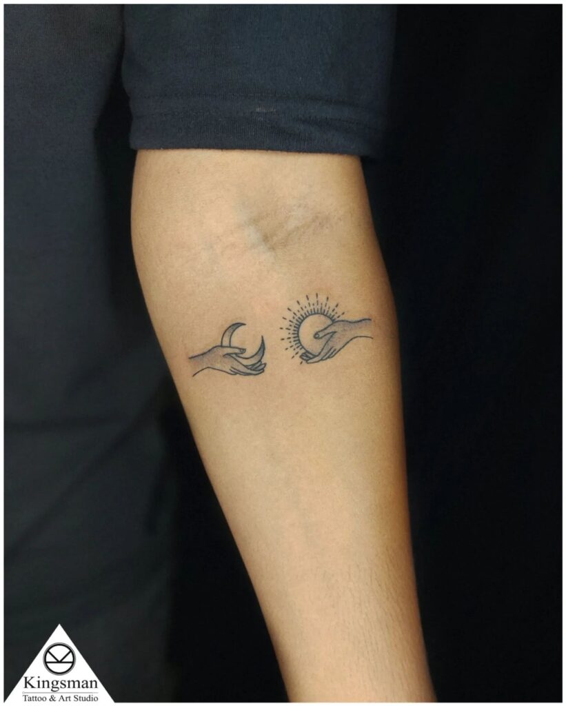 Holding Sun and Moon Hand Tattoo symbolic sun and moon tattoo ideas tattoo