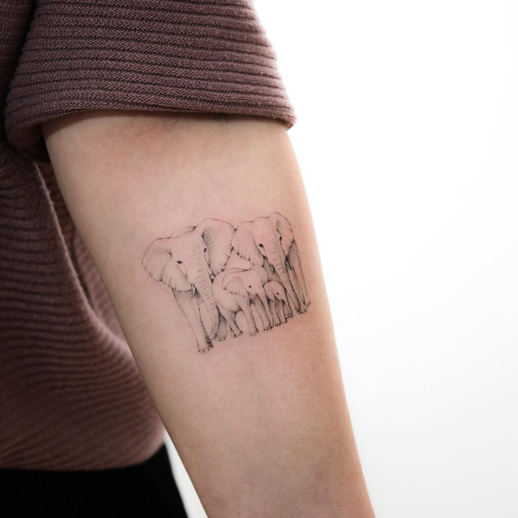 Huddled Elephant Family Tattoo elephant family tattoo ideas tattoo