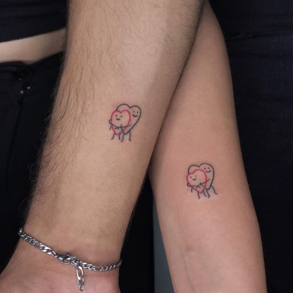 Hugging Hearts Couple Tattoos small couple tattoos tattoo