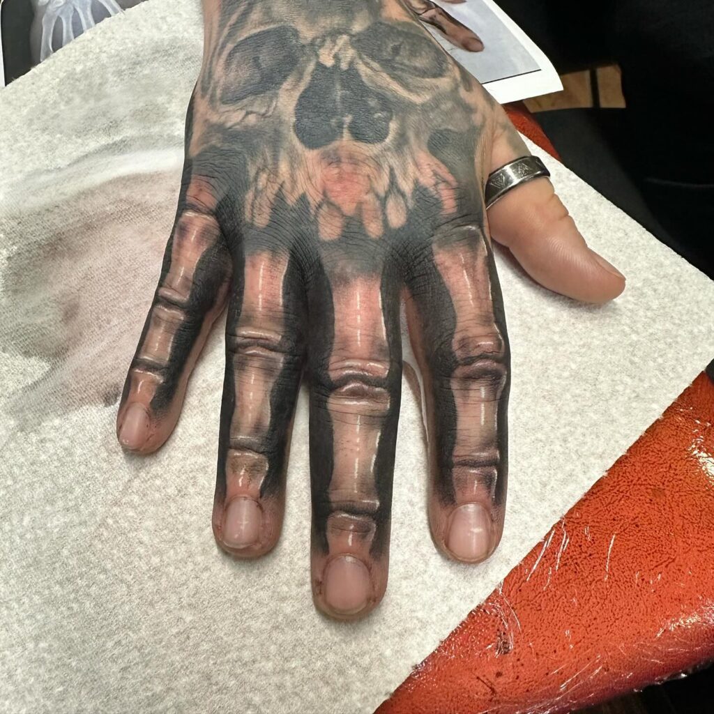 Minimalist Black Heart Finger Tattoo