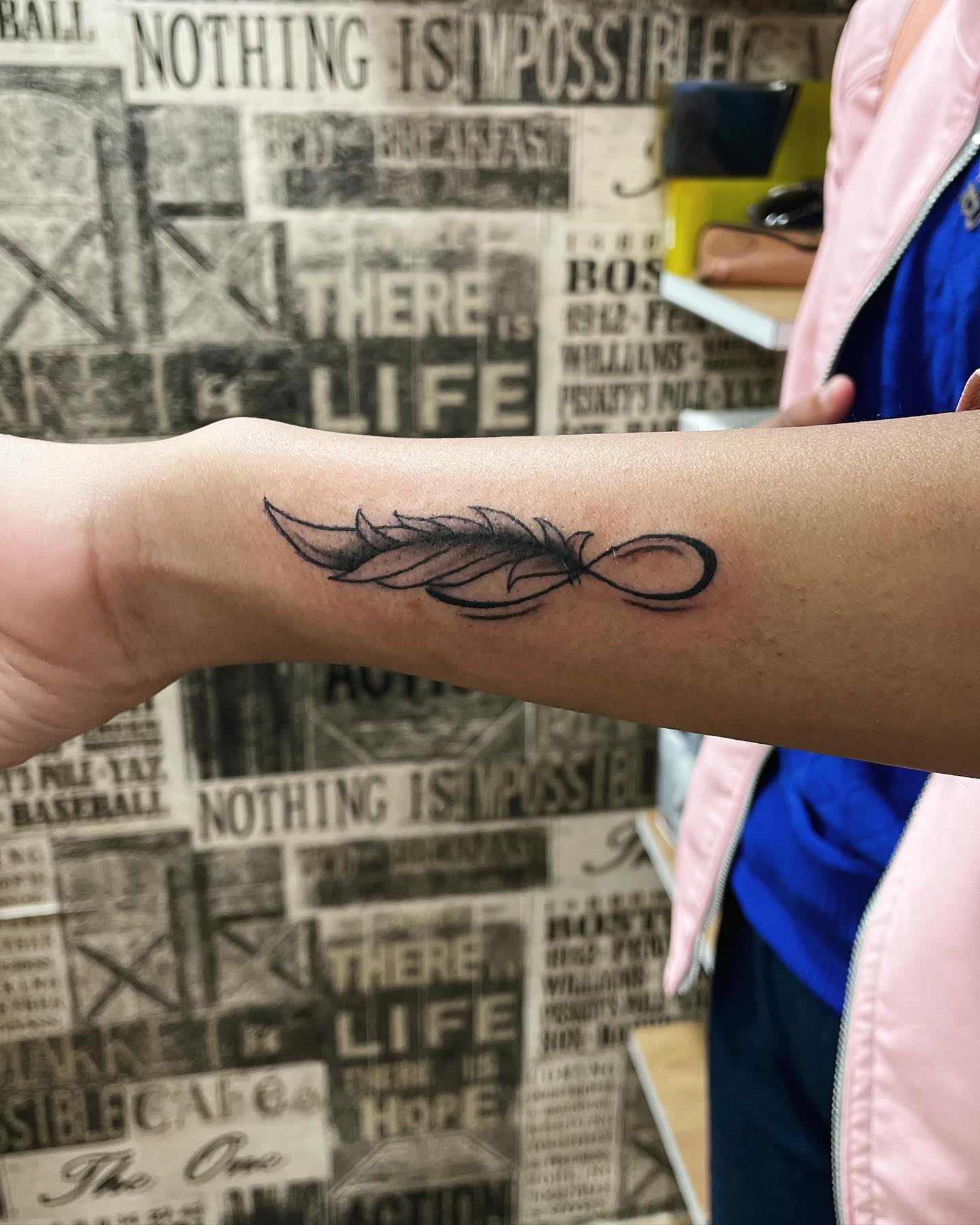 Realistic Black Feather Tattoo