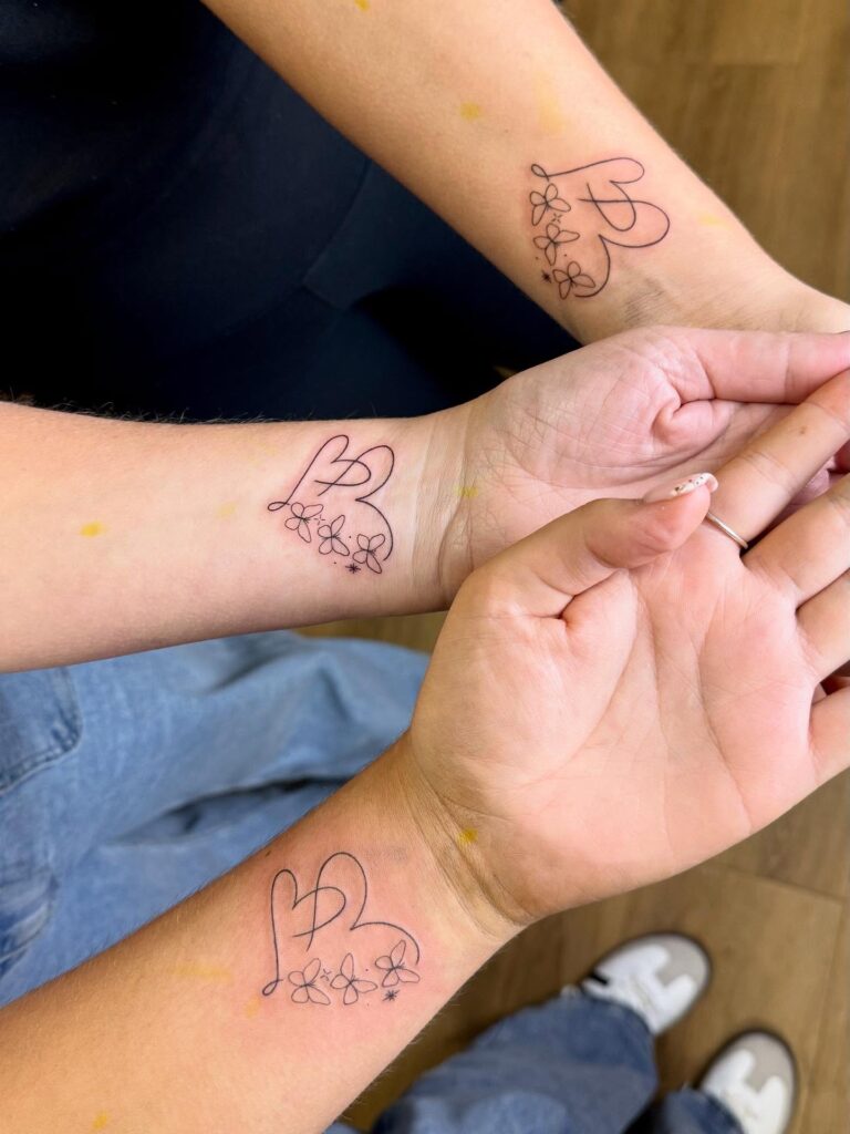 Interlocking Heart and Botanical Bloom matching family tattoo