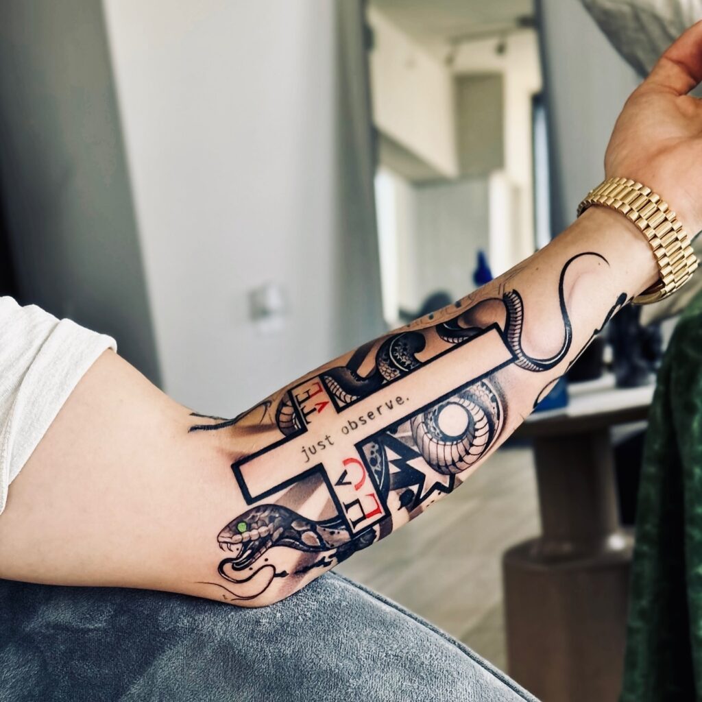 Intricate Cross with Snake and Symbolic Elements Forearm Tattoo cross tattoos for men tattoo