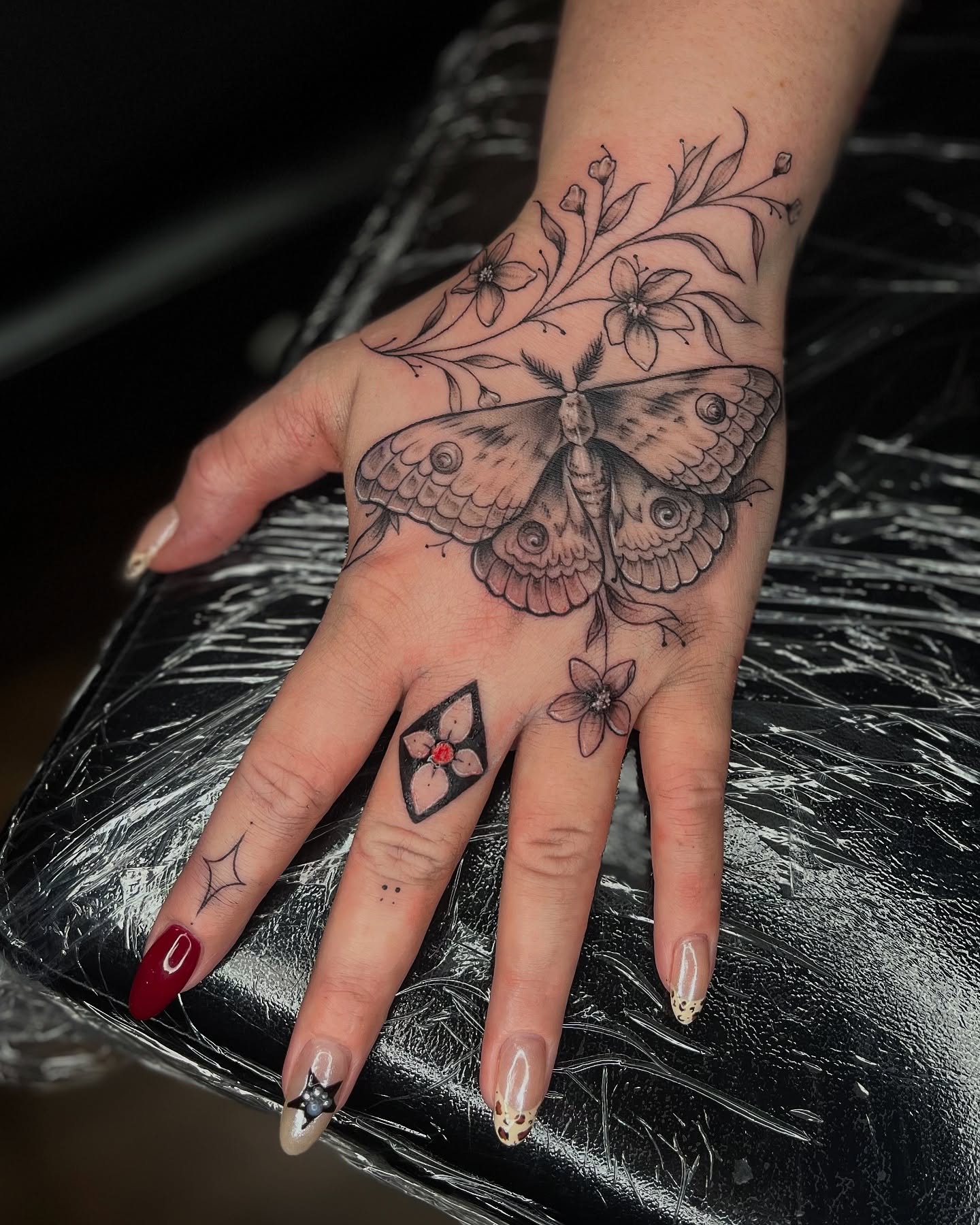 Flower And Butterfly Hand Tattoo