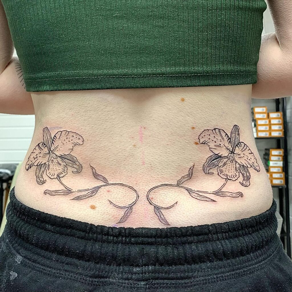 Bold Black Tribal Lower Back Tattoo