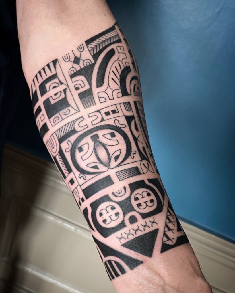 Polynesian-Inspired Face And Neck Tattoo