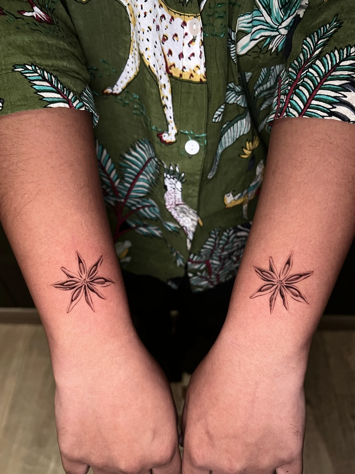 Matching Floral Star Forearm Tattoos