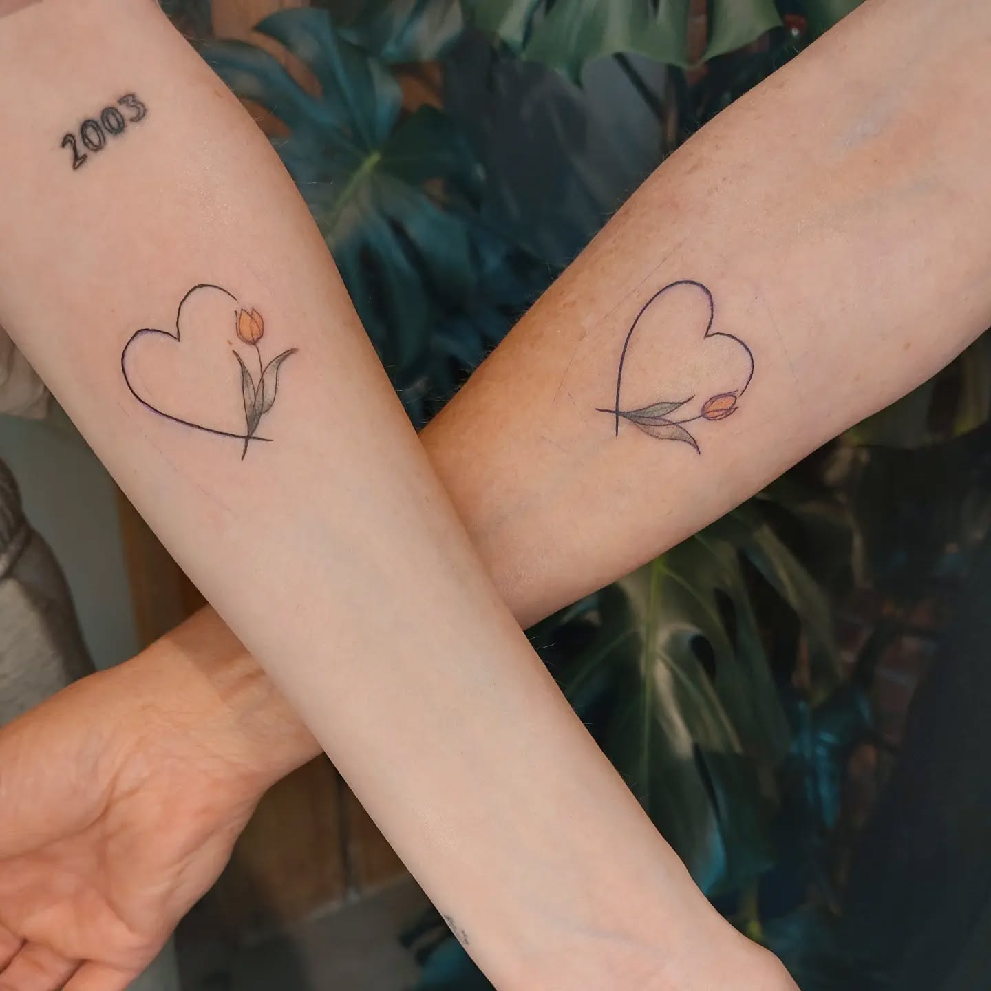 Matching Heart Outline Tattoos with Tulip Blooms unique mom and daughter tattoos tattoo