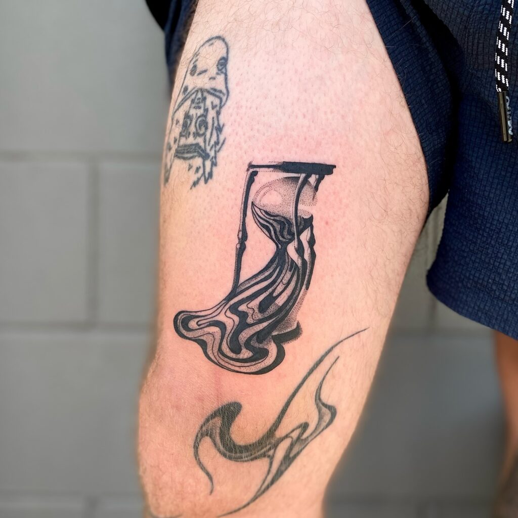 Melting Surreal Hourglass Thigh Tattoo hourglass tattoo ideas tattoo